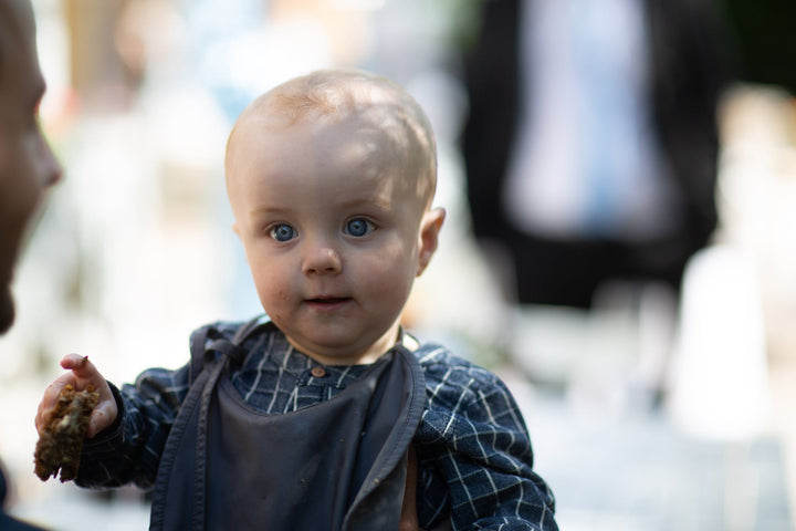 a young girl in blue and white plaid dress shirt
