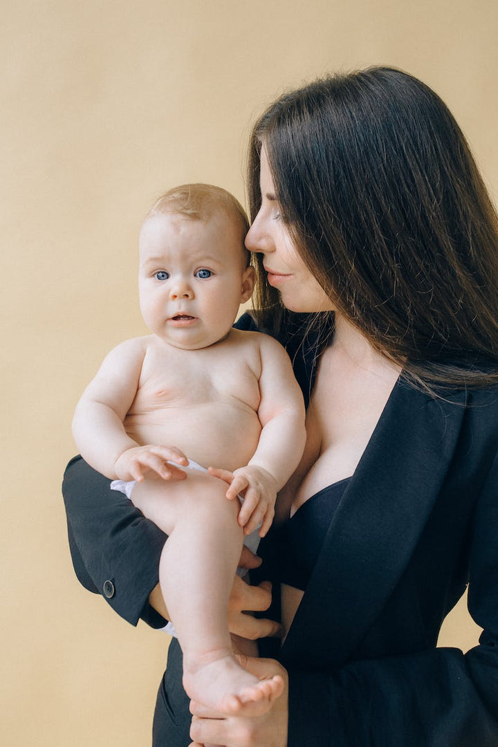 portrait of woman holding her baby|portrait of woman holding her baby