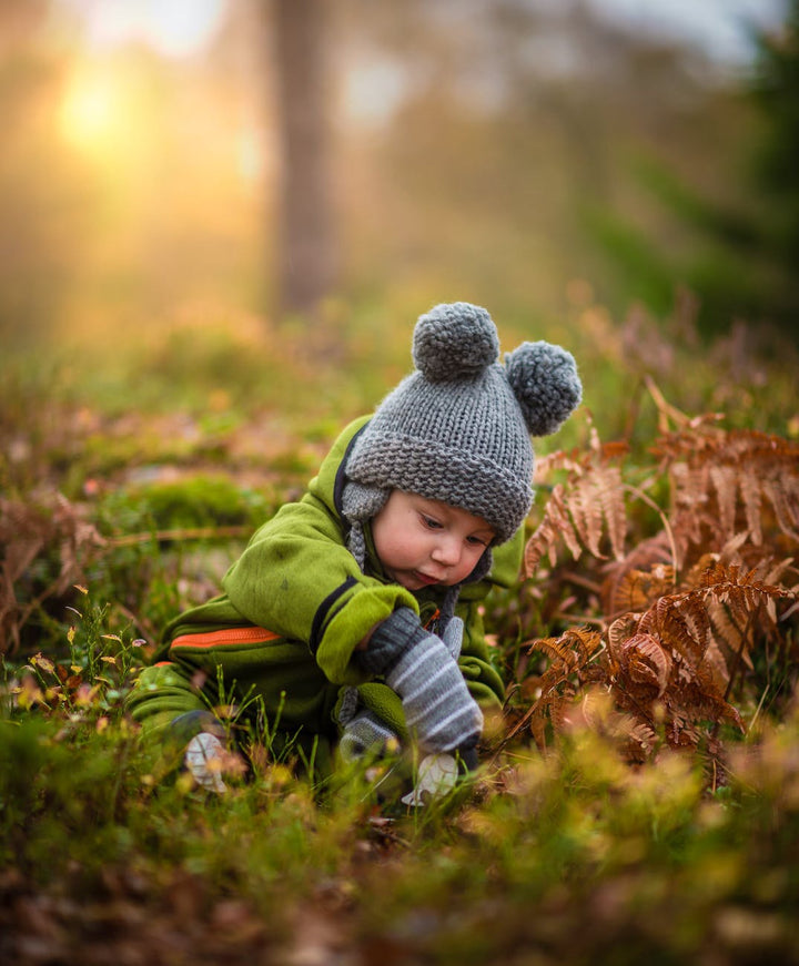 boy in gray knit hat|baby on fur rug