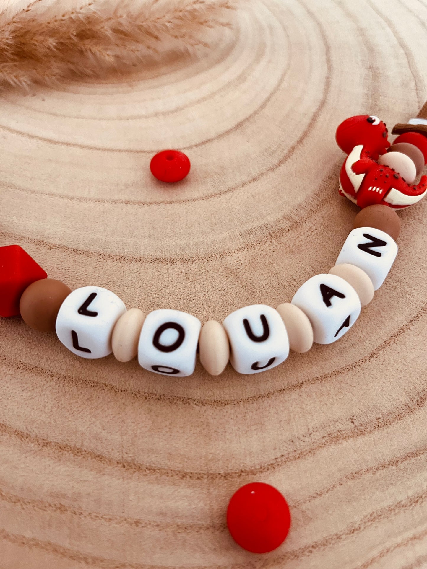 Attache-tétine personnalisée dinosaure rouge