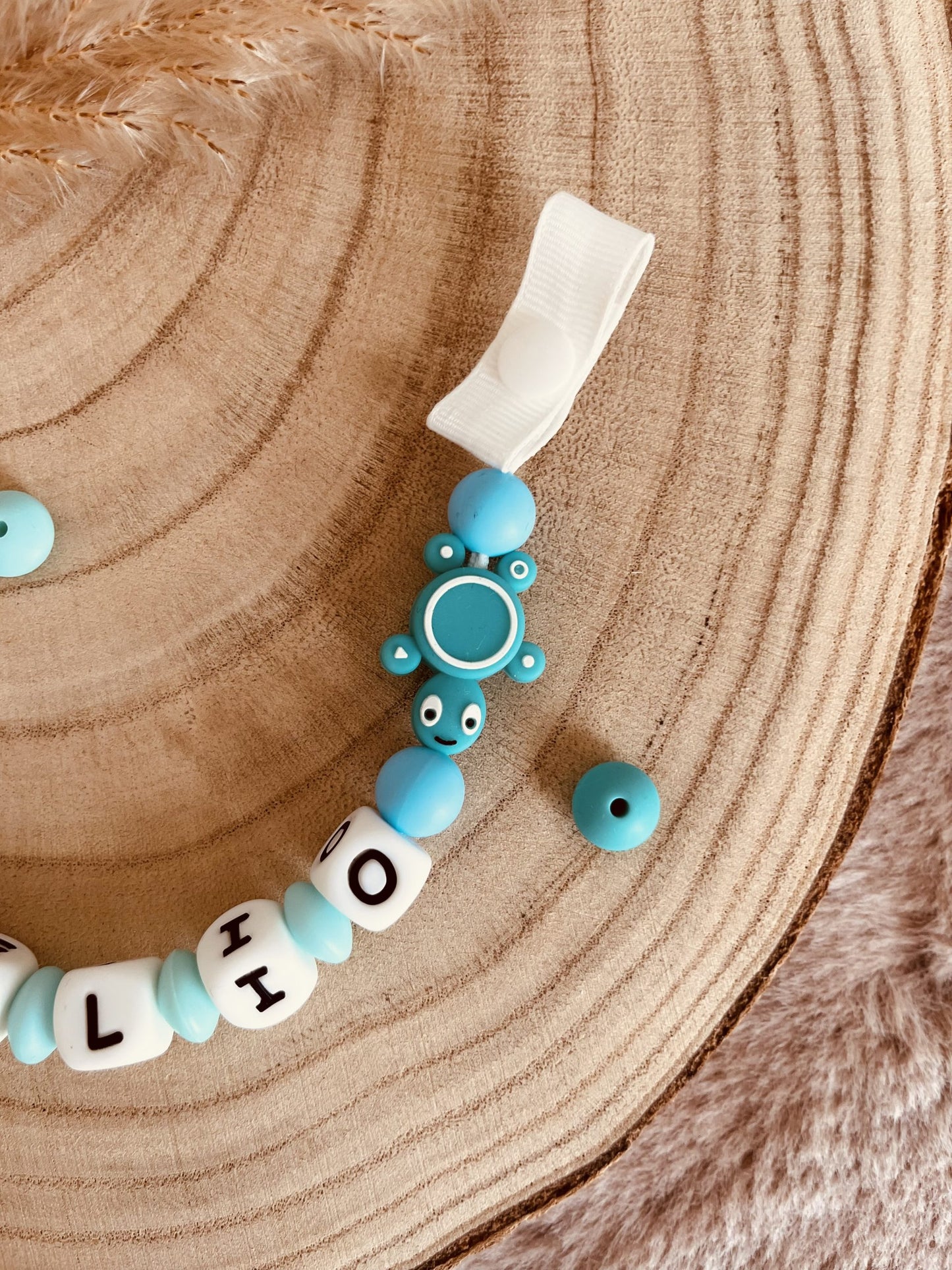 Turquoise turtle pacifier attach