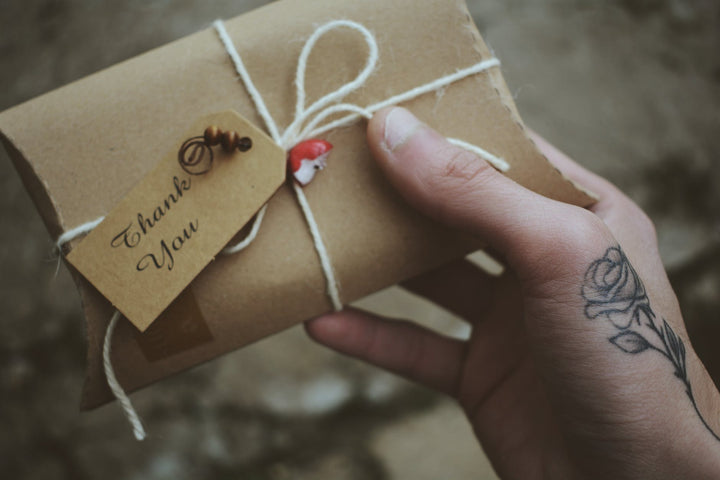 brown envelope with thank you printed card