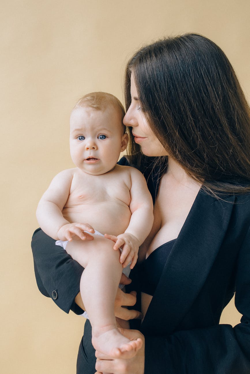 portrait of woman holding her baby|portrait of woman holding her baby