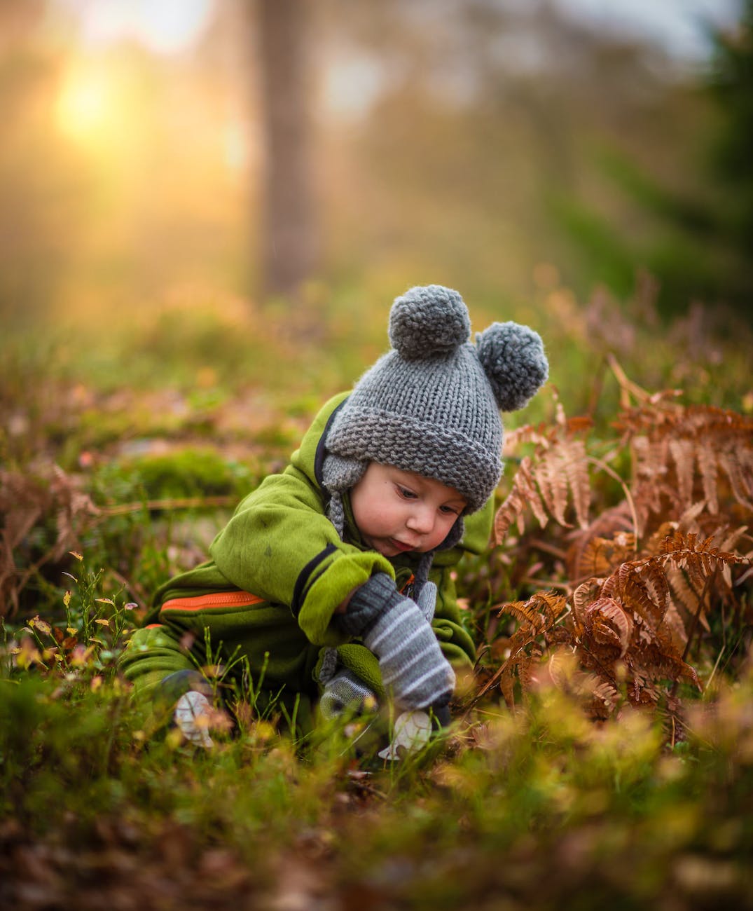 boy in gray knit hat|baby on fur rug
