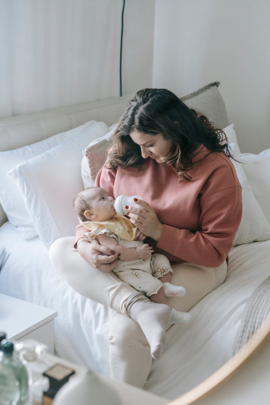 mother feeding baby from bottle