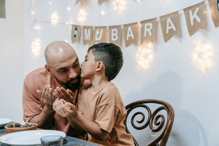 father and son sitting at the table|bearded man drinking coffee sitting near daughter and wife|mother and father walking with son|mother and father walking with son