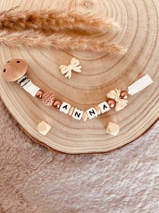 Attache tétine noeud beige