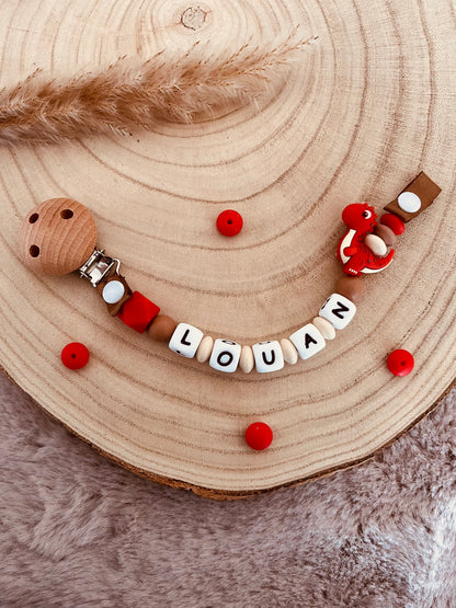 Attache-tétine personnalisée dinosaure rouge