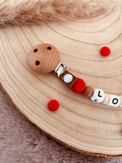 Attache-tétine personnalisée dinosaure rouge