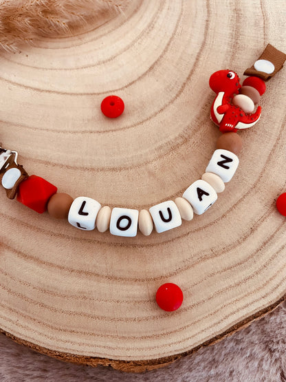 Attache-tétine personnalisée dinosaure rouge