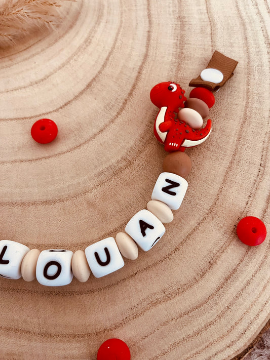 Attache-tétine personnalisée dinosaure rouge