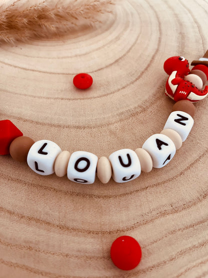 Attache-tétine personnalisée dinosaure rouge